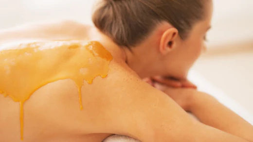 manuka honey on the back of female as holistic medicine