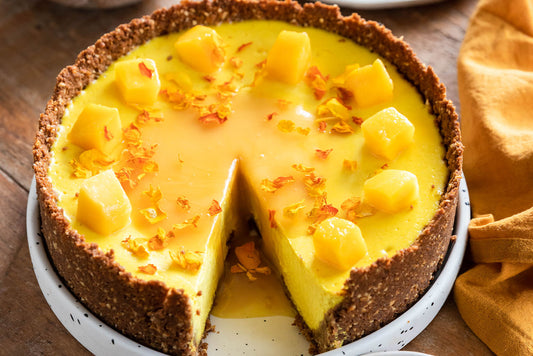 Cheesecake on plate with mango on top