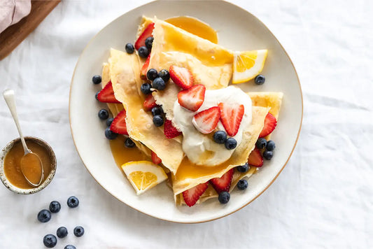 Plate of crepes with fruit on top