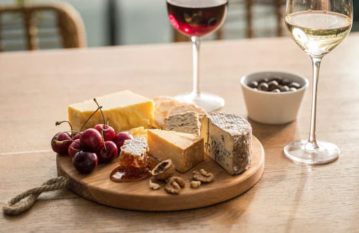 cheese board with wine glasses