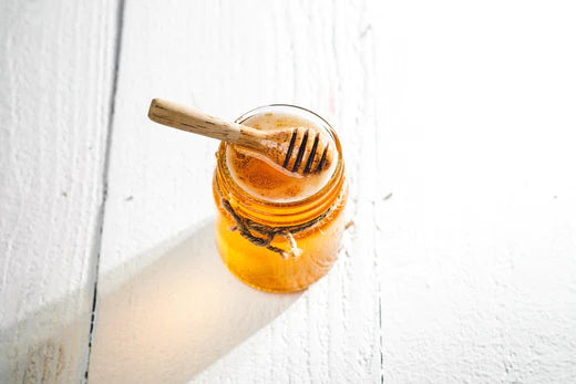 jar of honey and honey dipper