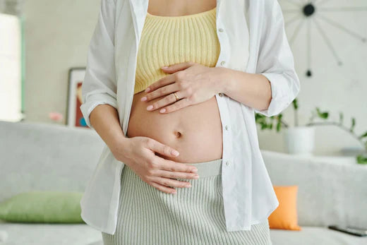 pregnant woman holding her belly